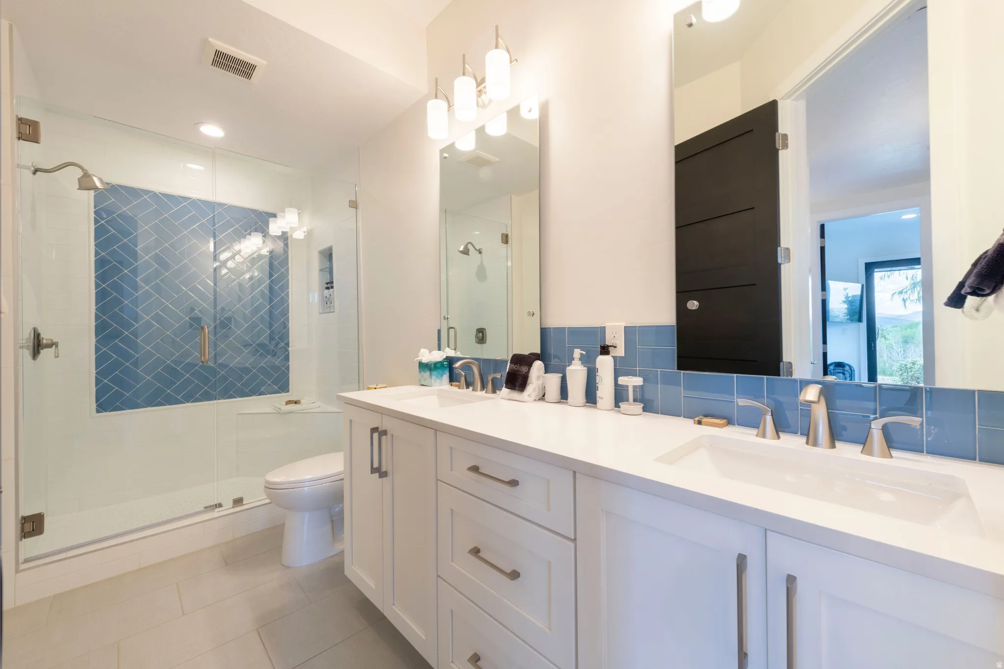 Dual vanity with white cabinetry and integrated sinks