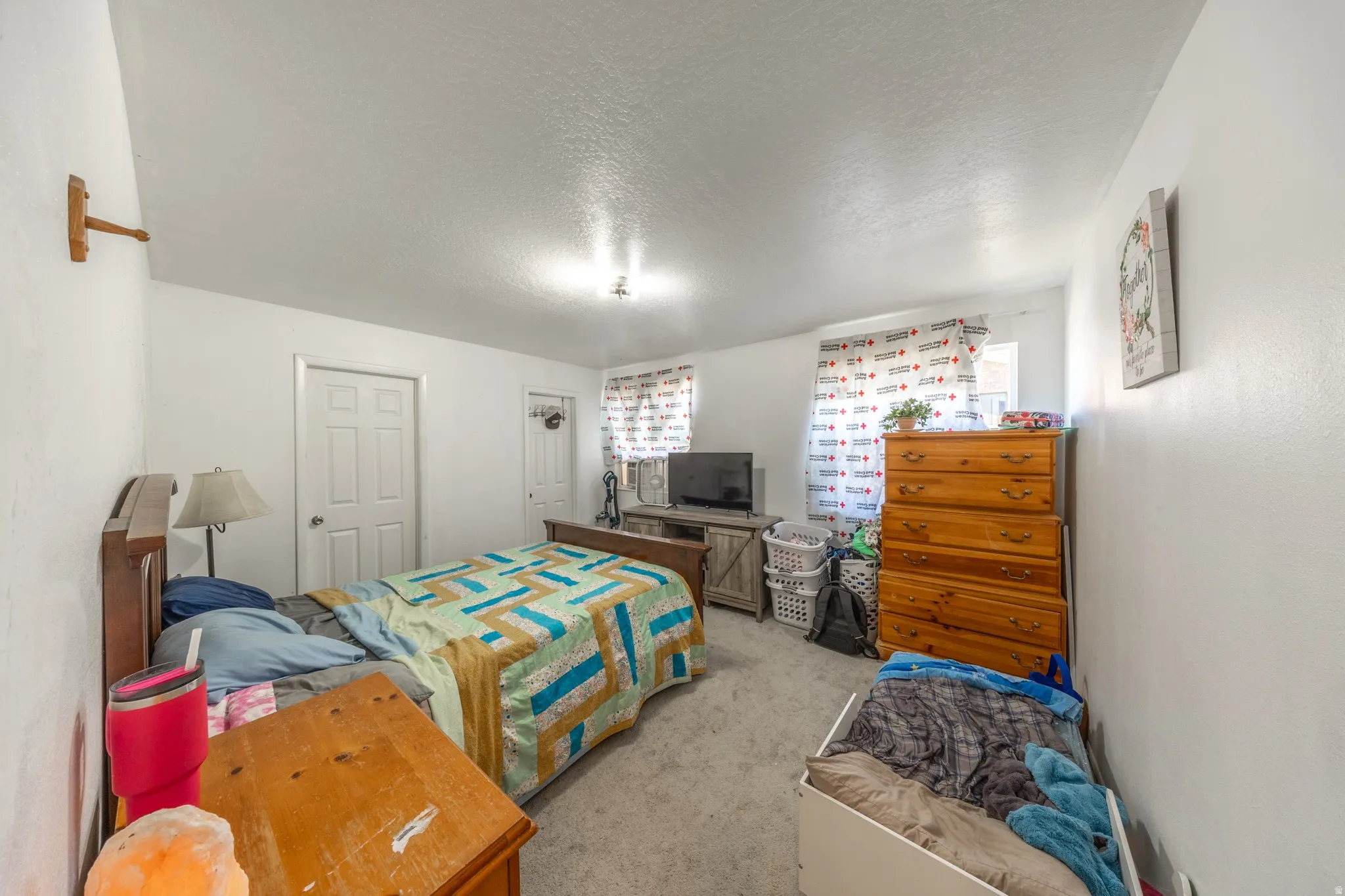 White painted walls and trim complement the light-colored carpeting