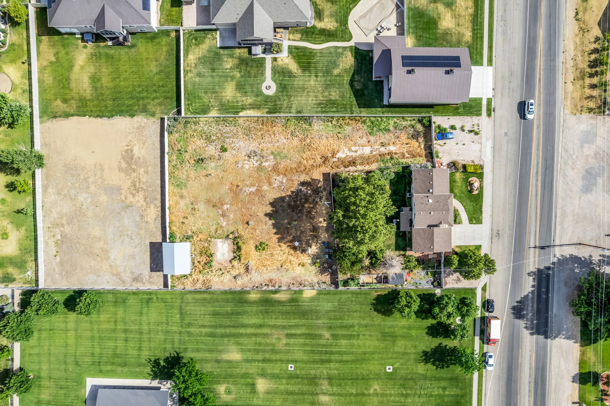 Expansive lot featuring a detached storage shed and mature trees