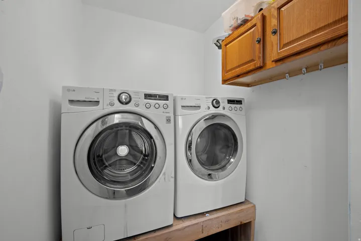 Wall-mounted cabinetry with wood-finish doors and brass hardware