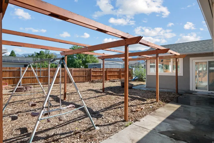 Wood pergola structure over a concrete patio