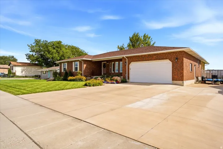 Spacious all brick Syracuse rambler offering 3,774 square feet, a fully landscaped .48 acre lot, and no HOA.