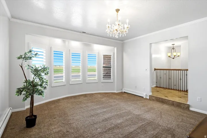 Plantation shutters and crown moulding add timeless character to the front living room.