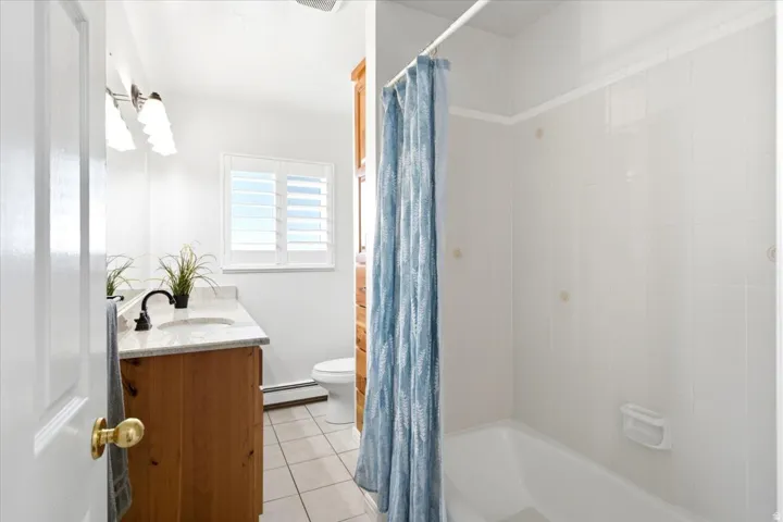 Another view of the updated main level bathroom, complete with a tub and shower combination.