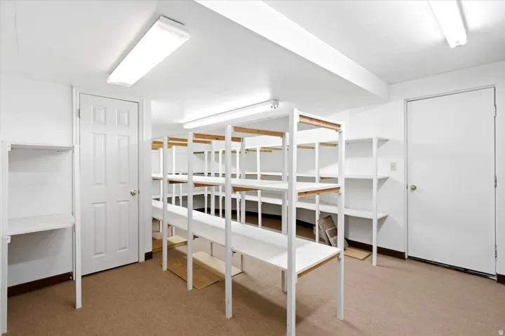 A huge basement storage room with extensive built-in shelving provides plenty of space to keep everything organized.