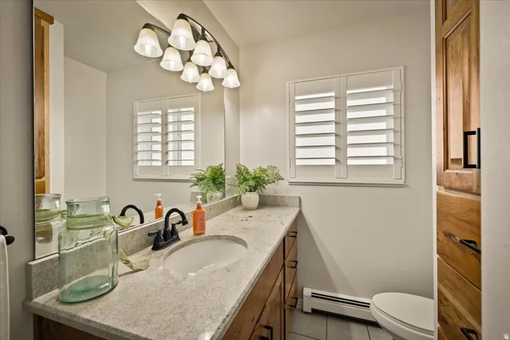 One of the home’s updated bathrooms features a spacious vanity and plantation shutters.