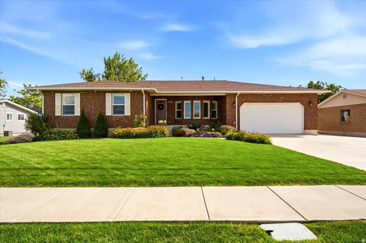 Spacious all brick Syracuse rambler offering 3,774 square feet, a fully landscaped .48 acre lot, and no HOA.