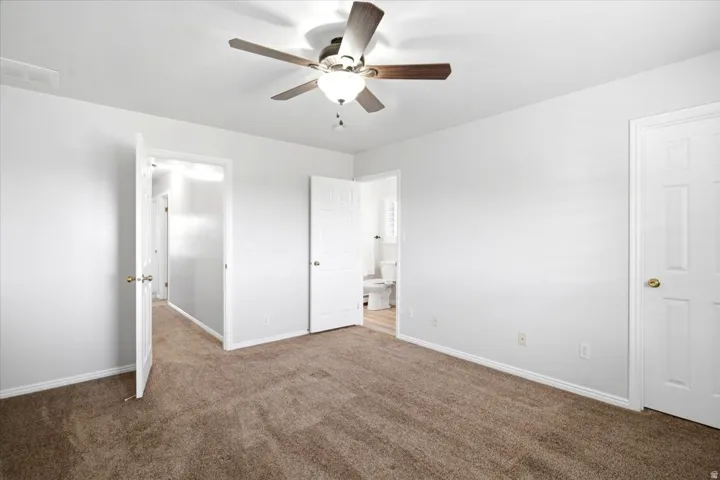 Another view of the spacious main level primary suite with its updated private bathroom and walk-in closet.