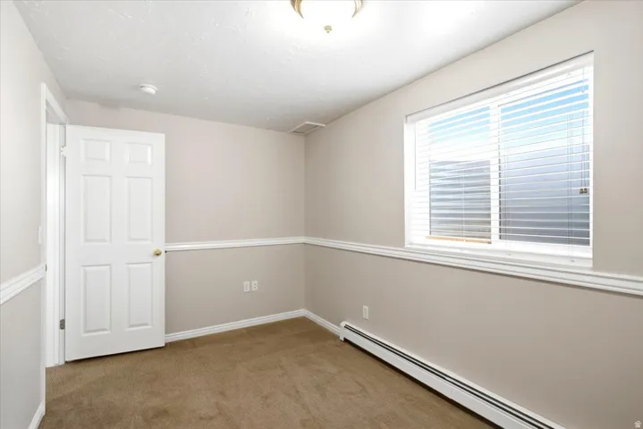 One of two basement bedrooms, offering additional space for household members or guests.