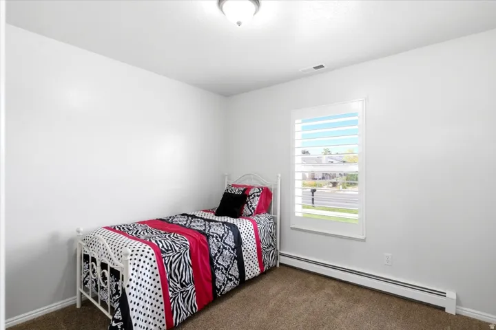 One of two additional bedrooms conveniently located on the main level.