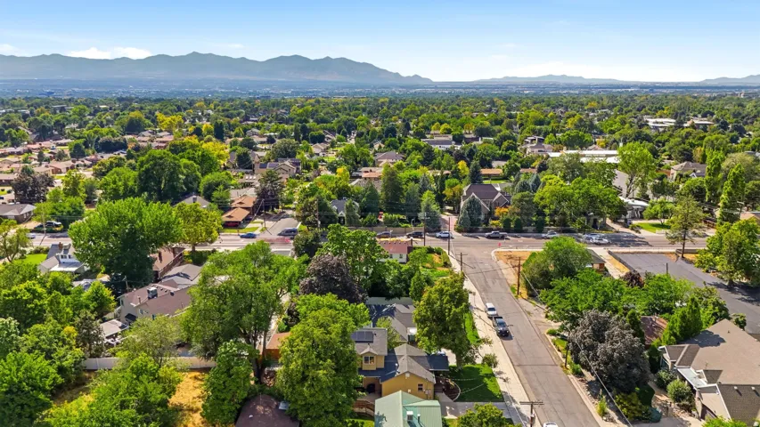 Expansive residential area with mature trees and mountain backdrop