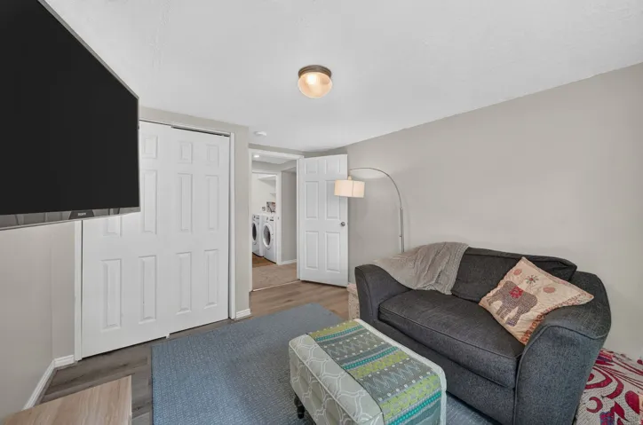 Wood-finish flooring with neutral wall tones and a ceiling-mounted light fixture