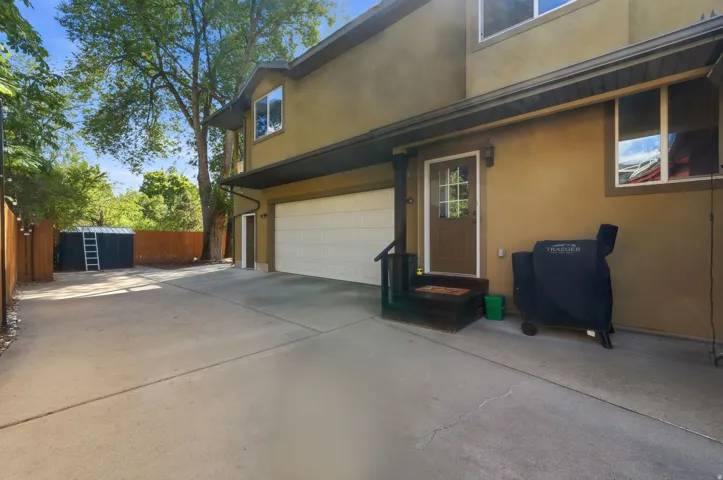 Two-story exterior with stucco finish, attached garage, private entry, and concrete driveway