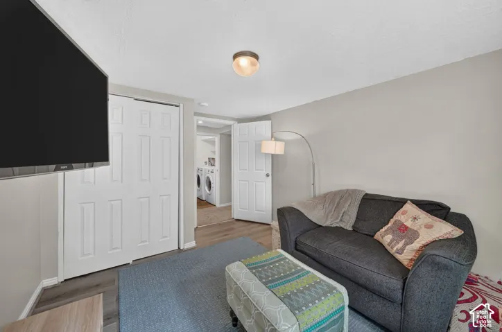 Wood-finish flooring with neutral wall tones and a ceiling-mounted light fixture