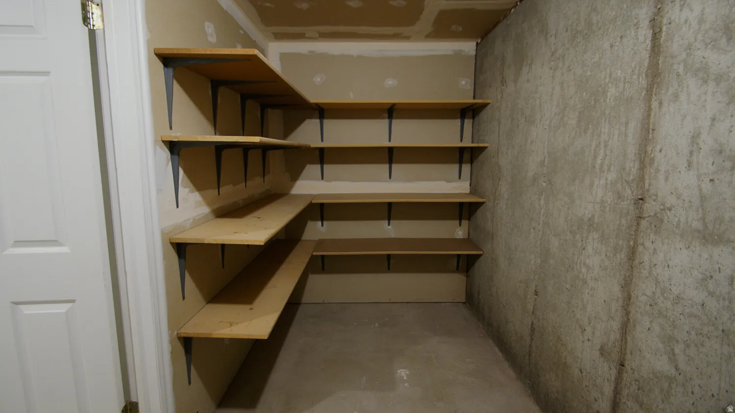Built-in wood shelving units with black metal brackets