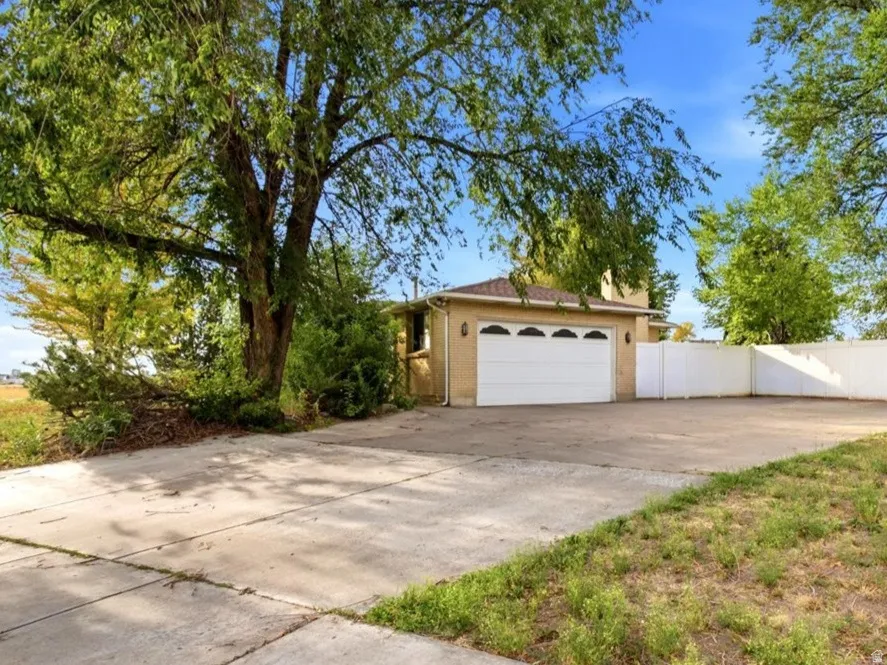 Attached garage with a white panel door