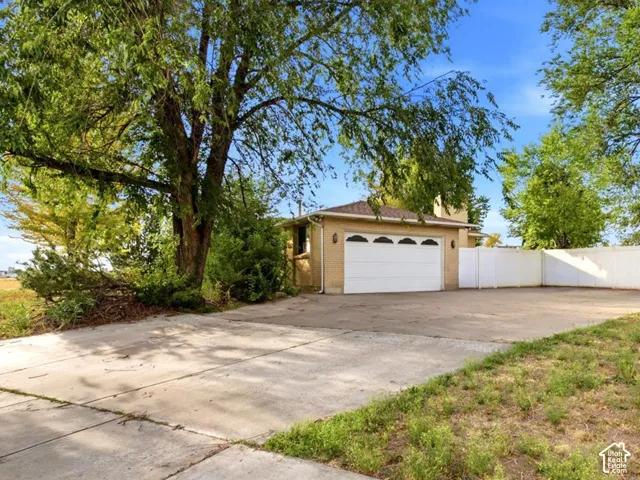 Attached garage with a white panel door
