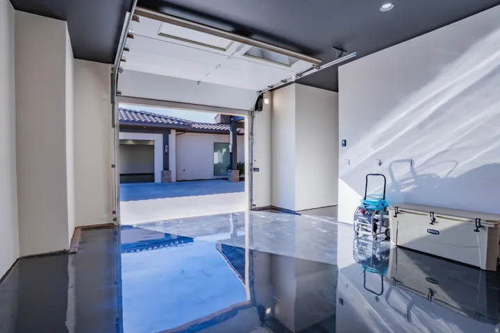Polished concrete flooring, recessed lighting, and a roll-up garage door