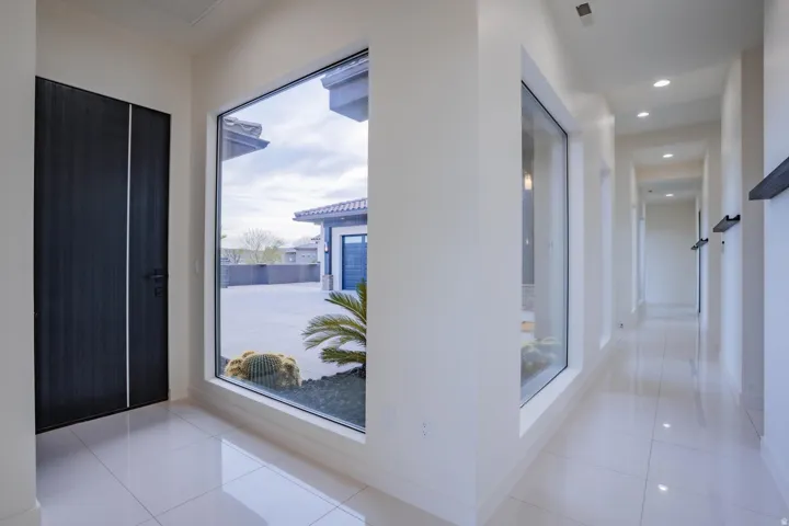 Tile flooring throughout, recessed lighting, and large fixed windows