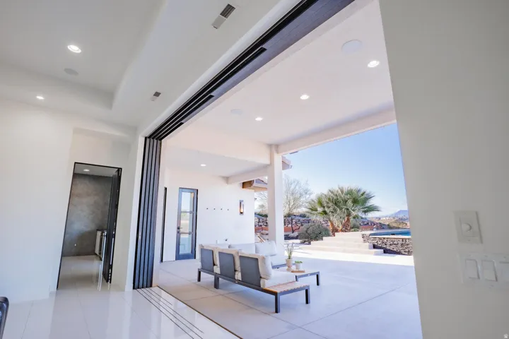 Expansive outdoor patio with concrete flooring and a built-in pool