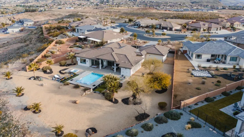 Contemporary single-story residence with a concrete tile roof, integrated swimming pool, and an in-ground spa