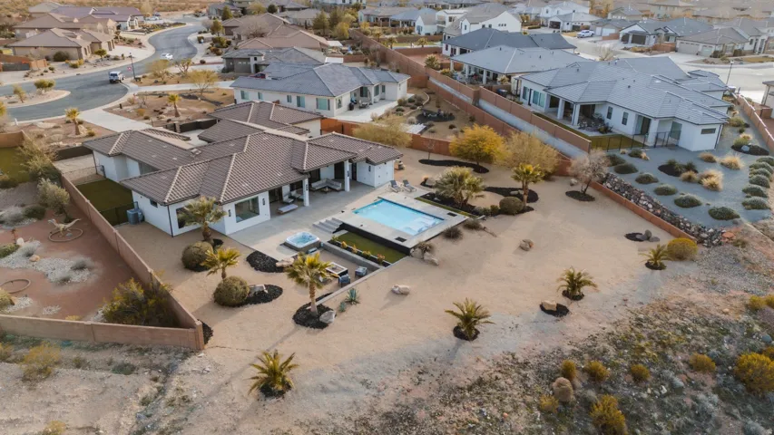 Exterior with a tile roof, an in-ground swimming pool, and an integrated spa