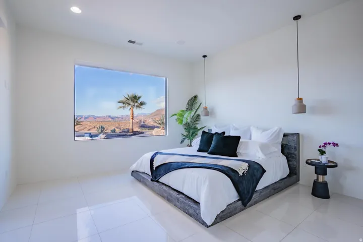 Expansive picture window, recessed ceiling lighting, light-toned flooring, and two pendant light fixtures