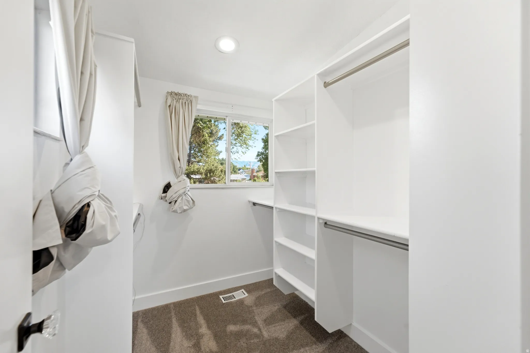 Built-in closet organization system featuring shelving and hanging rods