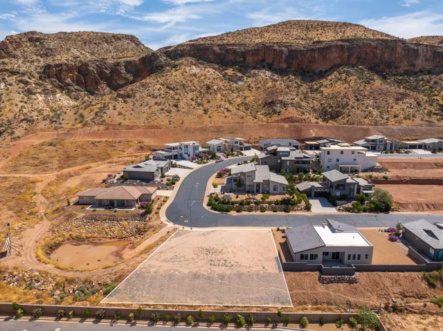 Cleared lot with a paved road, surrounded by established residential properties