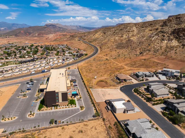 Expansive arid landscape surrounding a residential community and commercial building