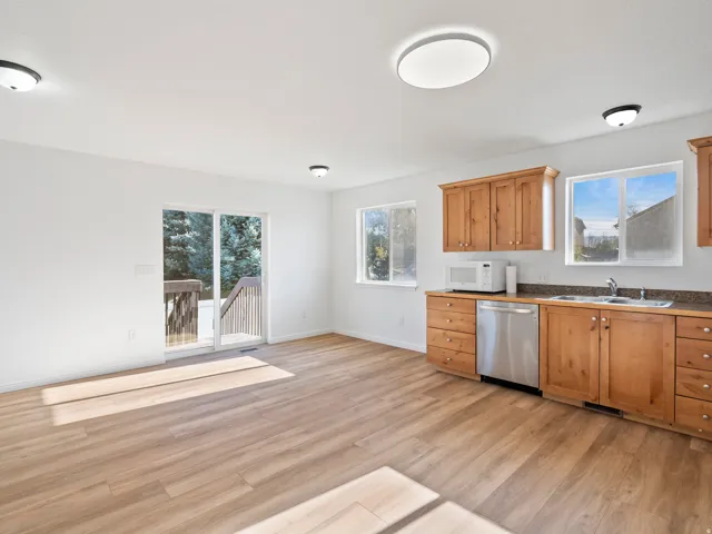 Wood-finish flooring with white walls and natural wood cabinetry