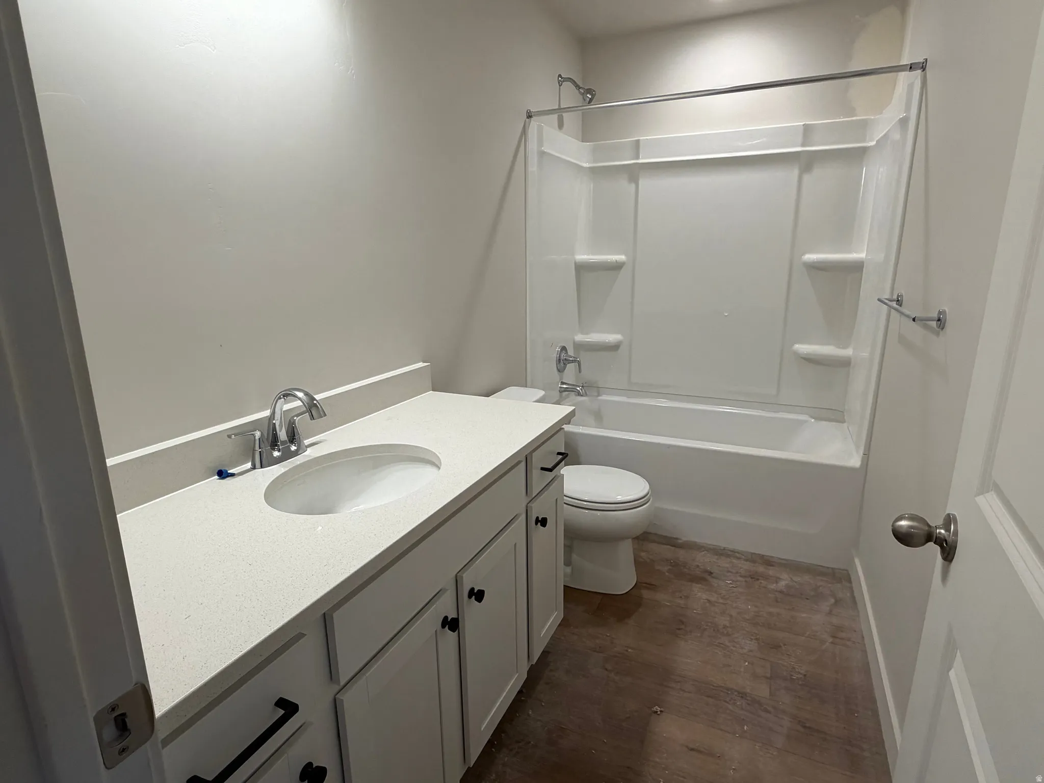 Vanity with an integrated sink, polished chrome faucet, white cabinetry, and a white countertop