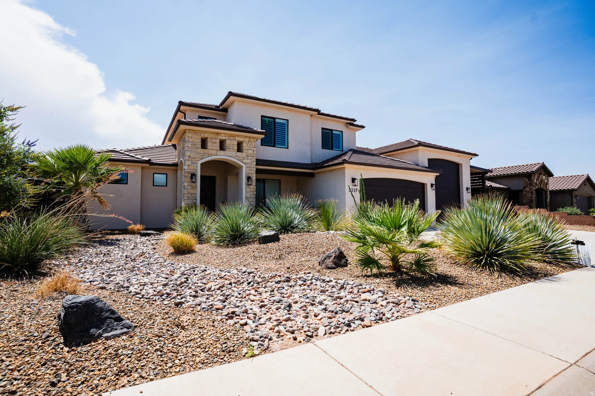 Stucco exterior with stone accents and dark trim