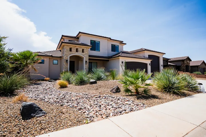 Stucco exterior with stone accents and dark trim