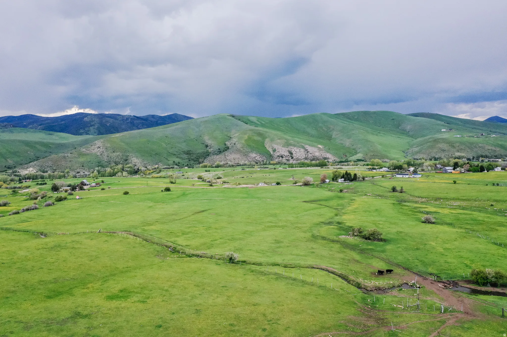Expansive green landscape with rolling hills and distant mountains