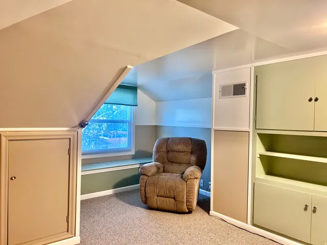 Large attic bedroom with lots of built-in storage