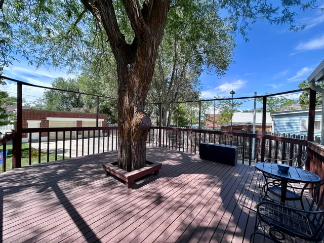 Fun deck with bench surrounding the large shade tree in the middle