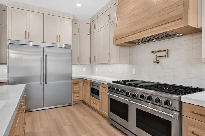 Stainless steel double oven range, built-in refrigerator, and microwave