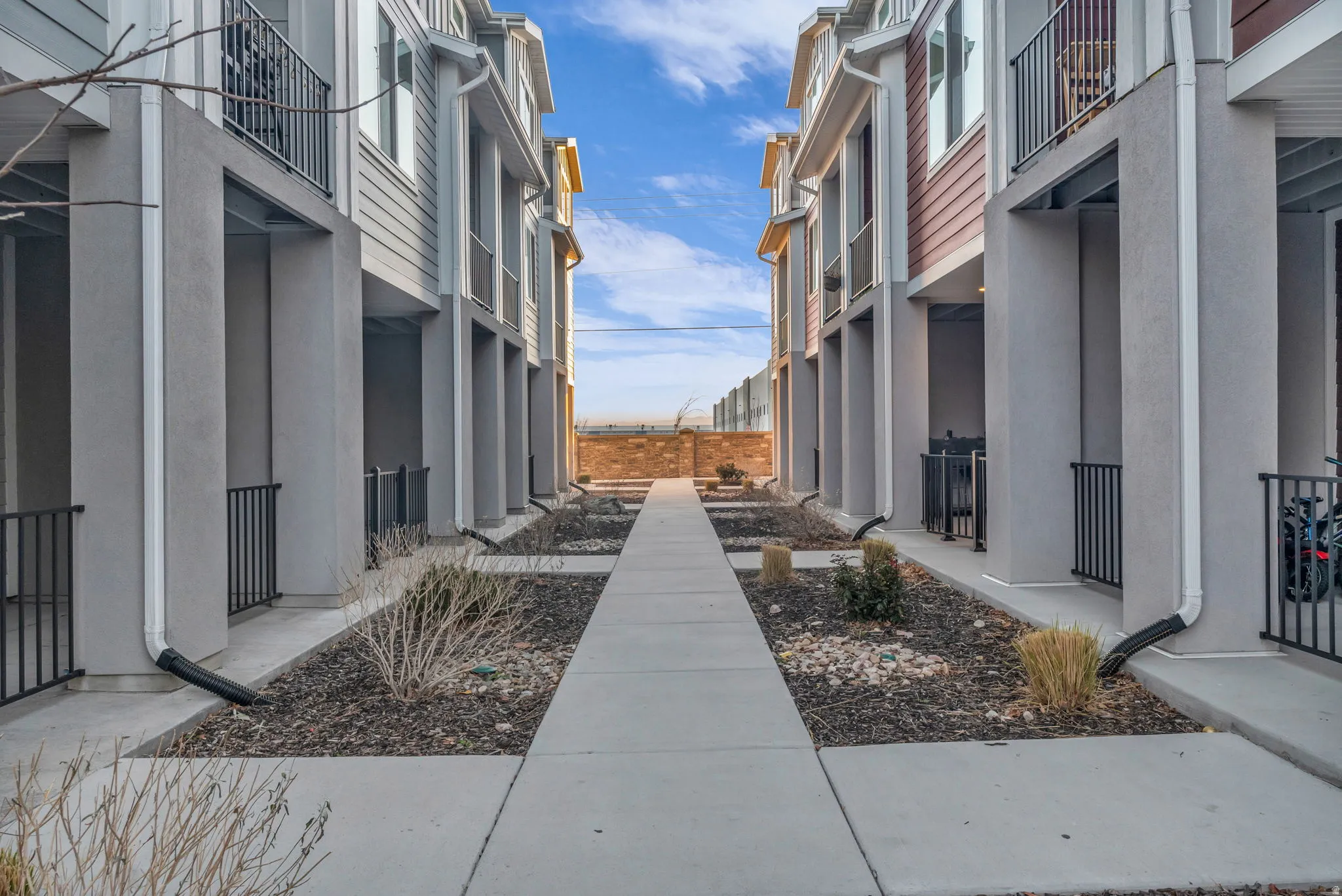 Modern townhome exteriors featuring horizontal siding and stucco finishes