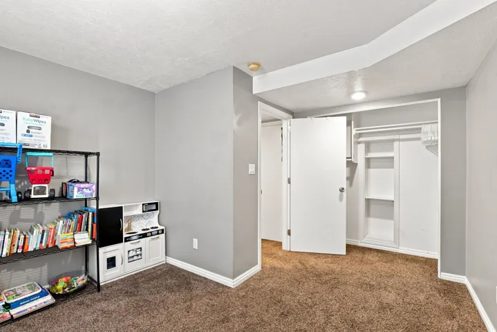 Wall-to-wall carpeting with light gray walls, white trim, and a white ceiling