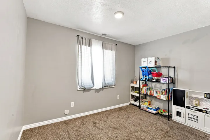 Neutral-toned walls complement plush carpeting