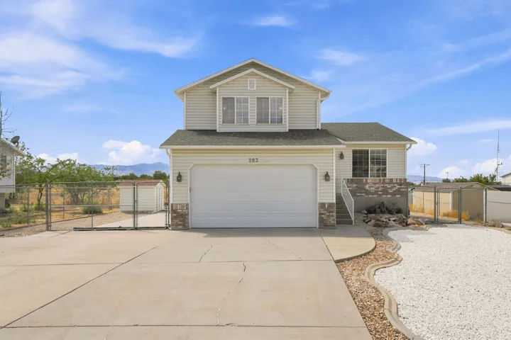 Two-story residence with light-toned siding and a two-car attached garage