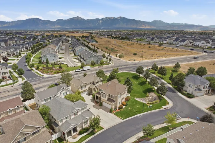 Aerial perspective showcasing a residential neighborhood with mountain scenery