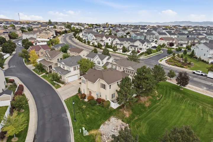 Residential neighborhood with a variety of architectural styles, paved streets, and landscaped common areas