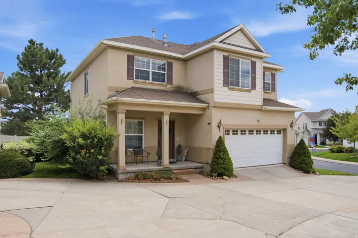 Two-story stucco exterior with gabled roof lines