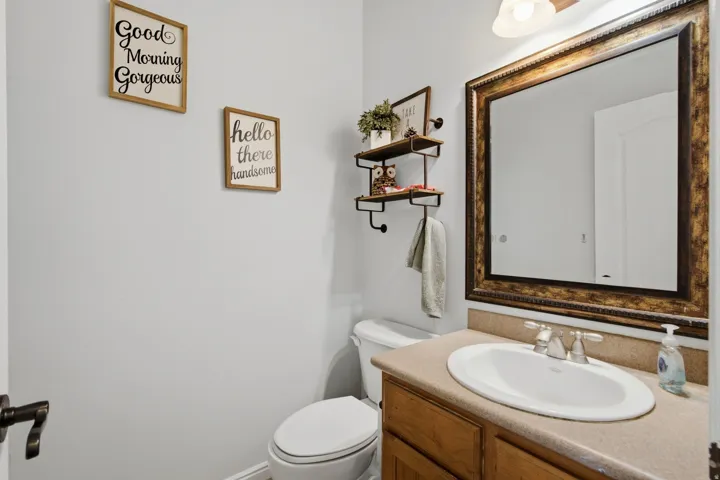 Wood-finish vanity with an integrated sink and brushed nickel faucet