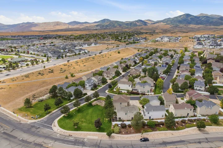 Residential neighborhood with established homes, paved streets, and mountainous backdrop