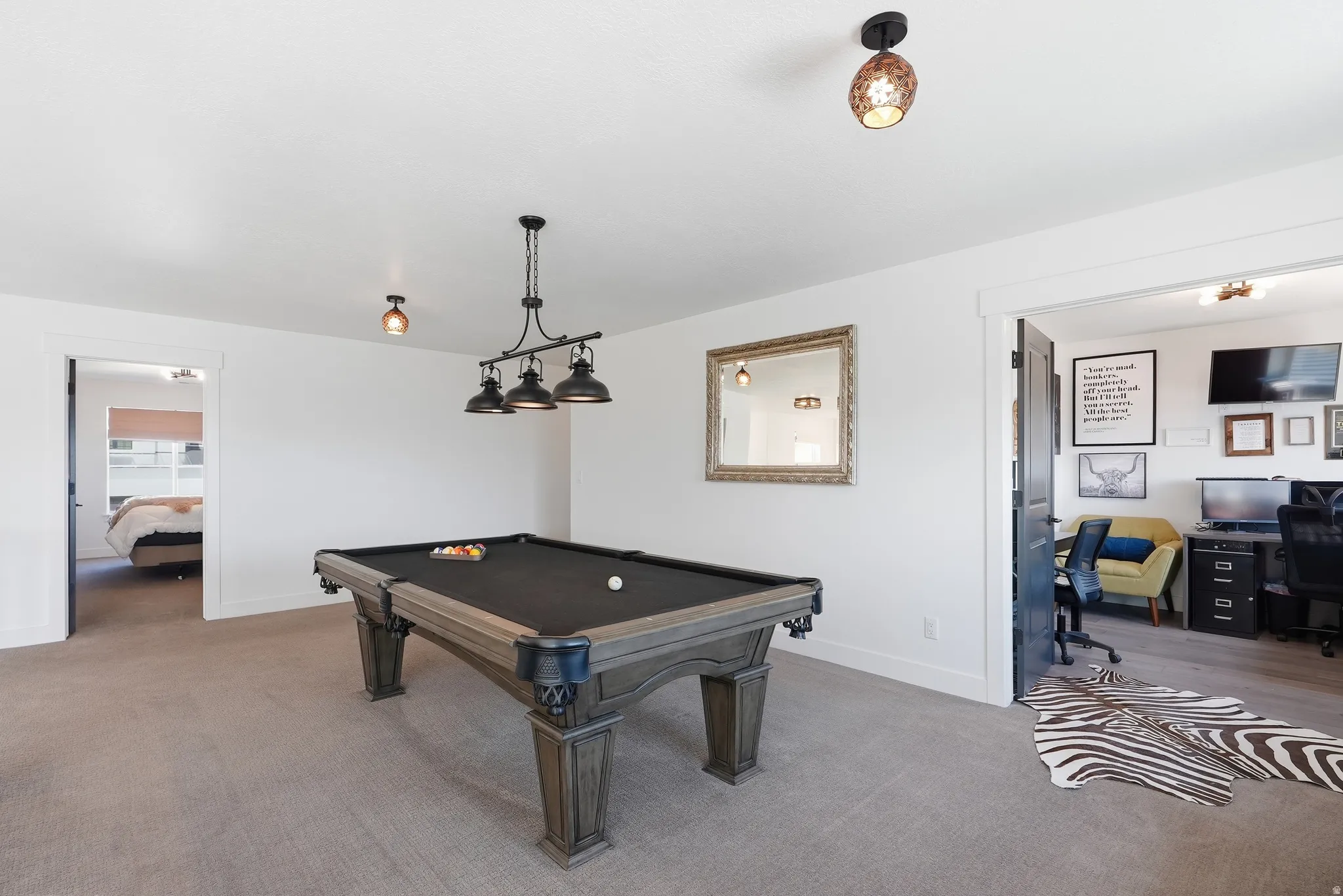 Recessed lighting and ceiling-mounted light fixtures illuminate the carpeted area