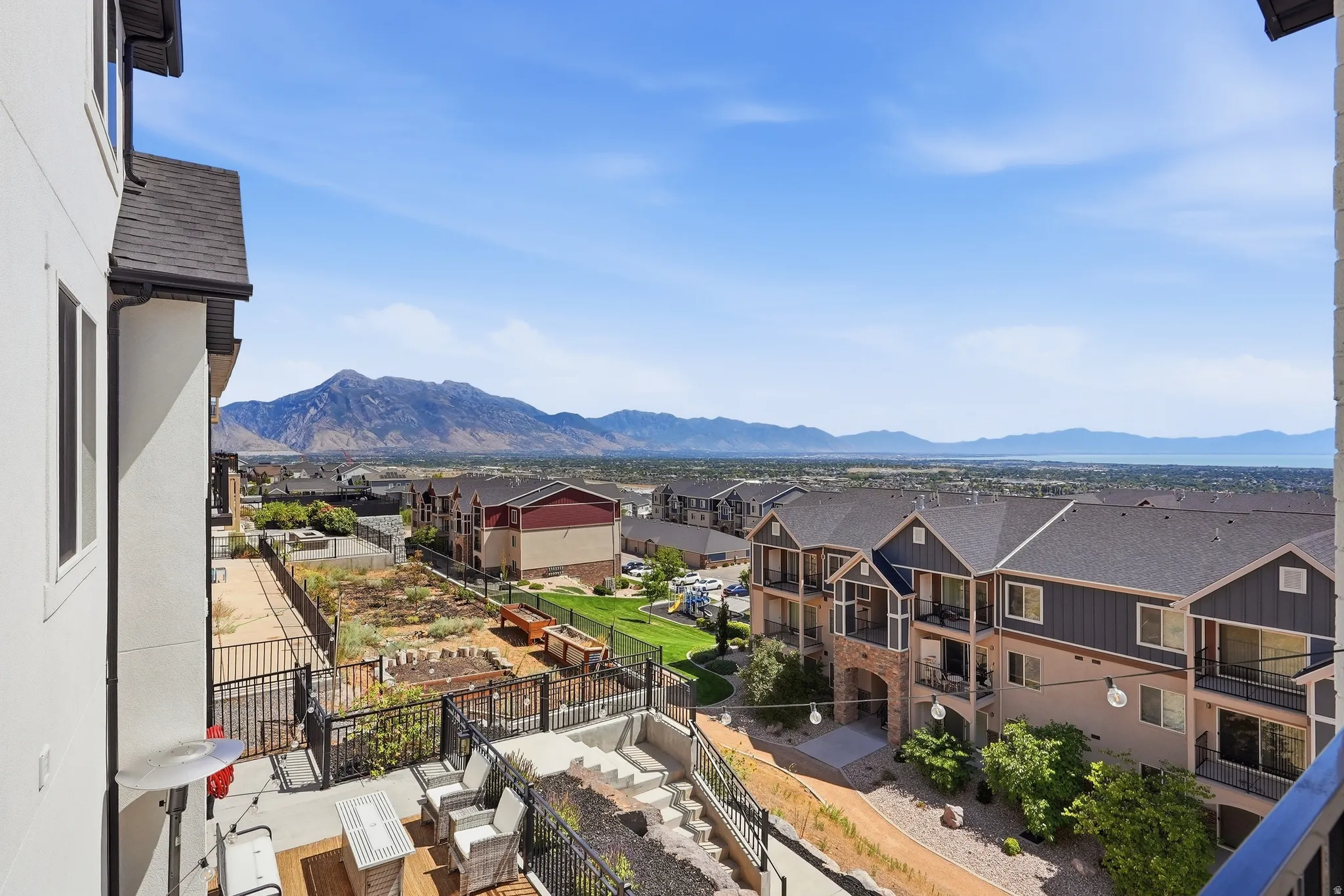 Mountain and lake scenery with residential structures in the foreground