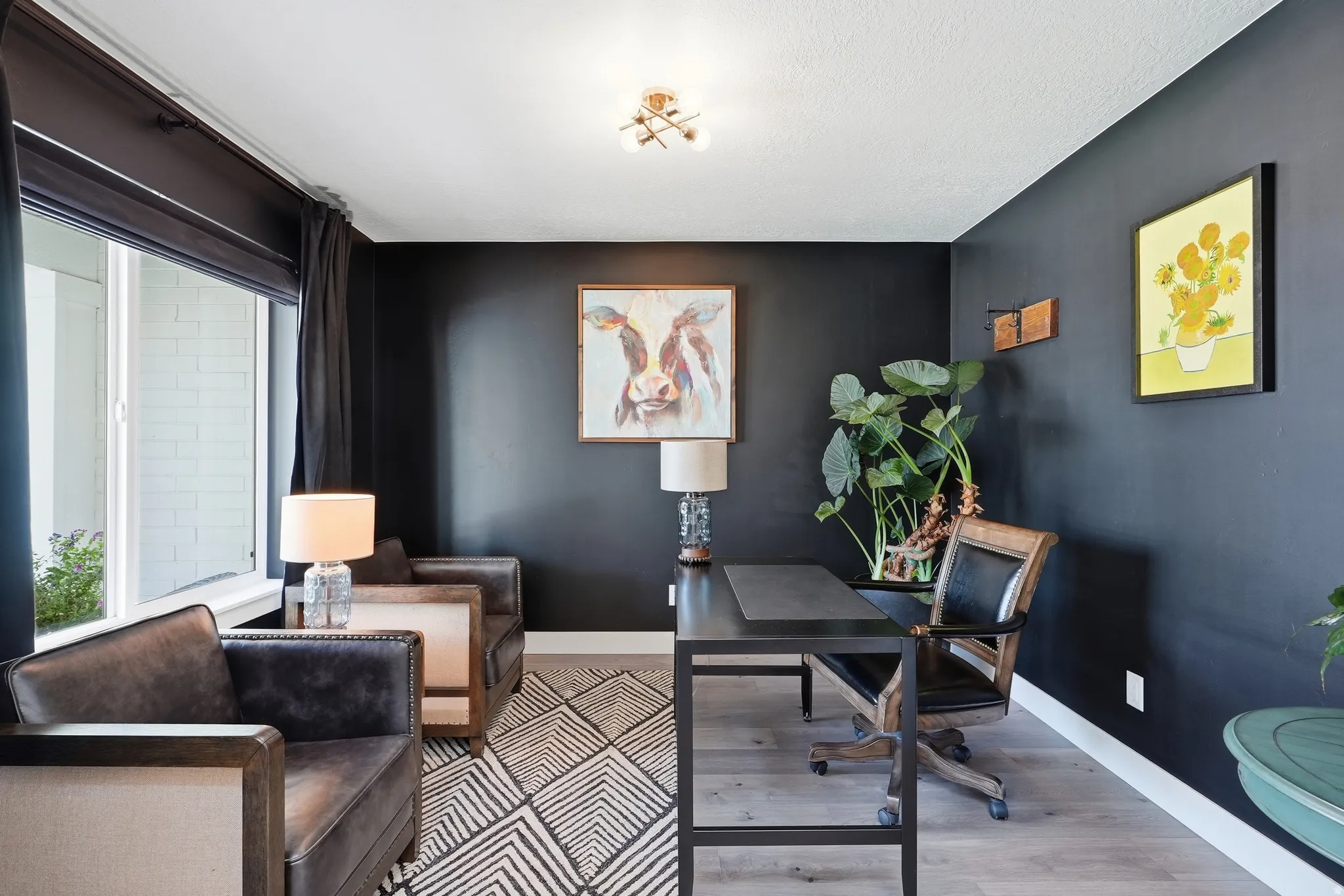 Recessed lighting, wood-finish flooring, and a large window with roller shades